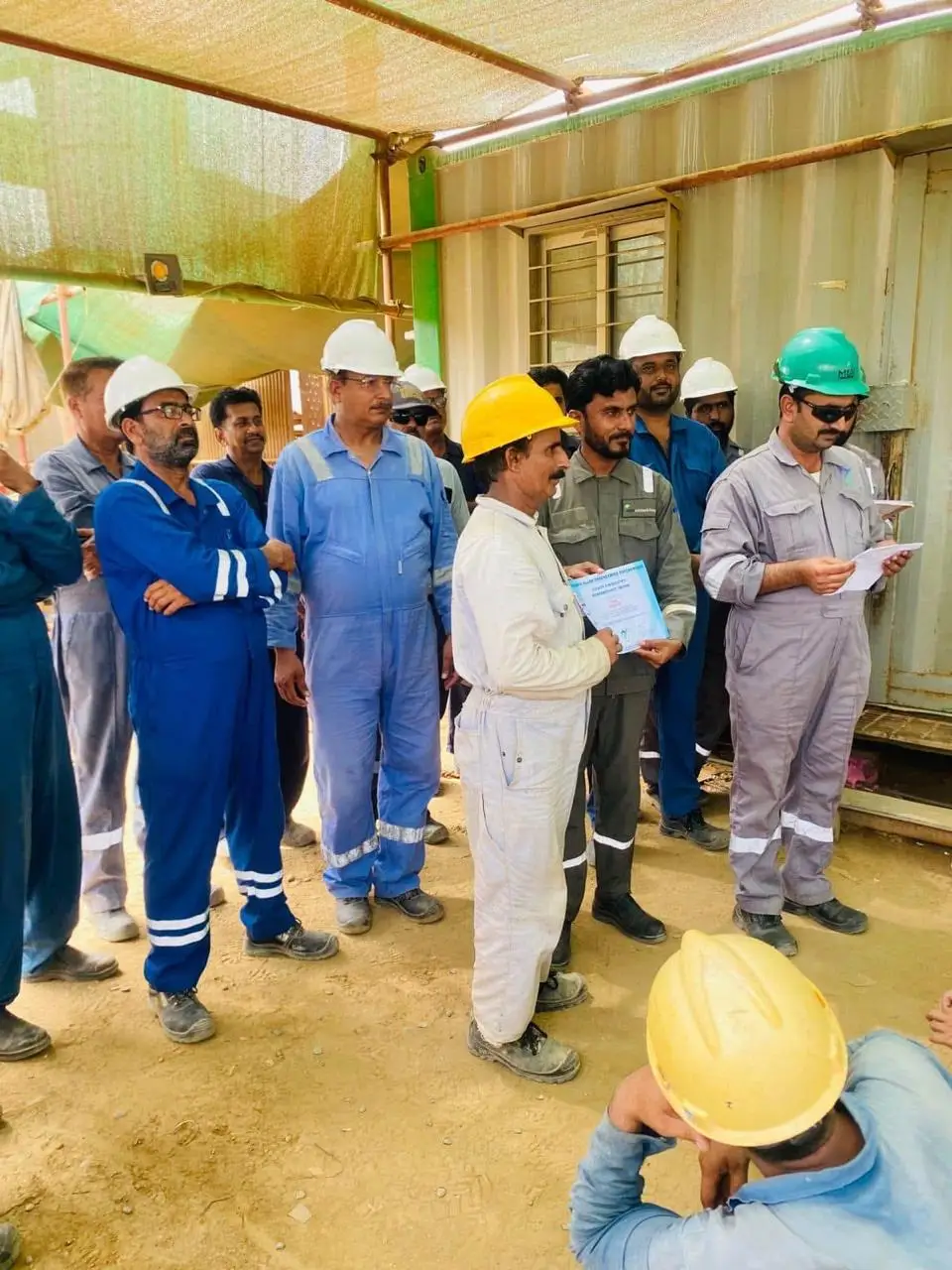 MEEC management presenting a recognition certificate to a team member