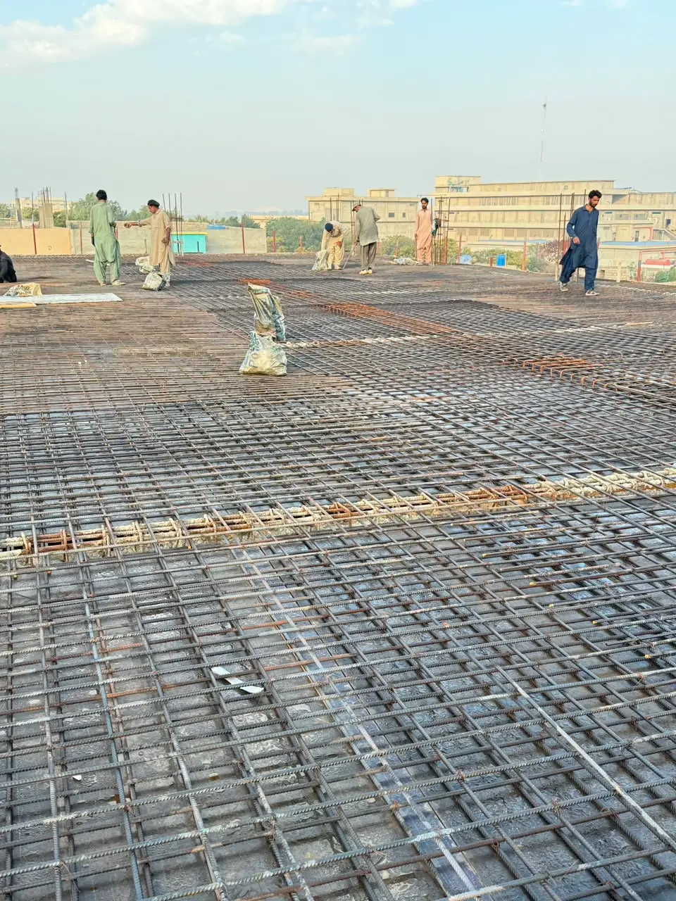 Civil crew working on a rebar-reinforced concrete roof deck